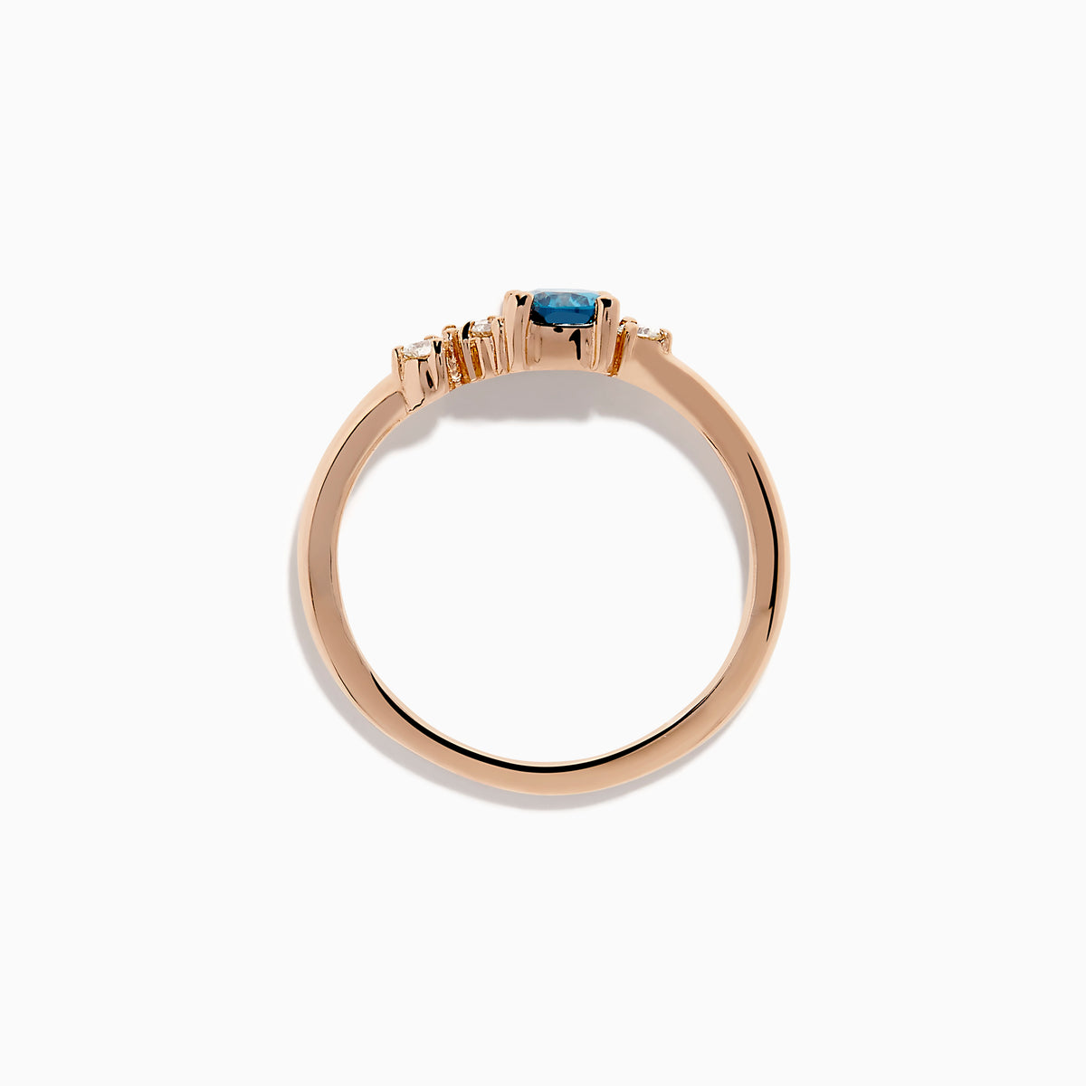 The 14K Rose Gold Blue and White Diamond Ring features a square-cut blue gemstone at the center with small round white diamonds on one side, displayed on a plain white background.
