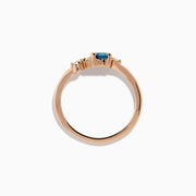 The 14K Rose Gold Blue and White Diamond Ring features a square-cut blue gemstone at the center with small round white diamonds on one side, displayed on a plain white background.