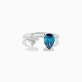 The 14K White Gold Blue and White Diamond Toi Et Moi Ring features a pear-shaped blue diamond and a square white diamond set side by side on an open band, displayed against a white background.