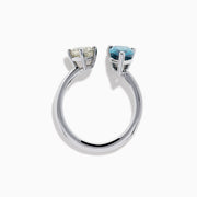 The 14K White Gold Blue and White Diamond Toi Et Moi Ring features a pear-shaped blue diamond and a square white diamond set side by side on an open band, displayed against a white background.
