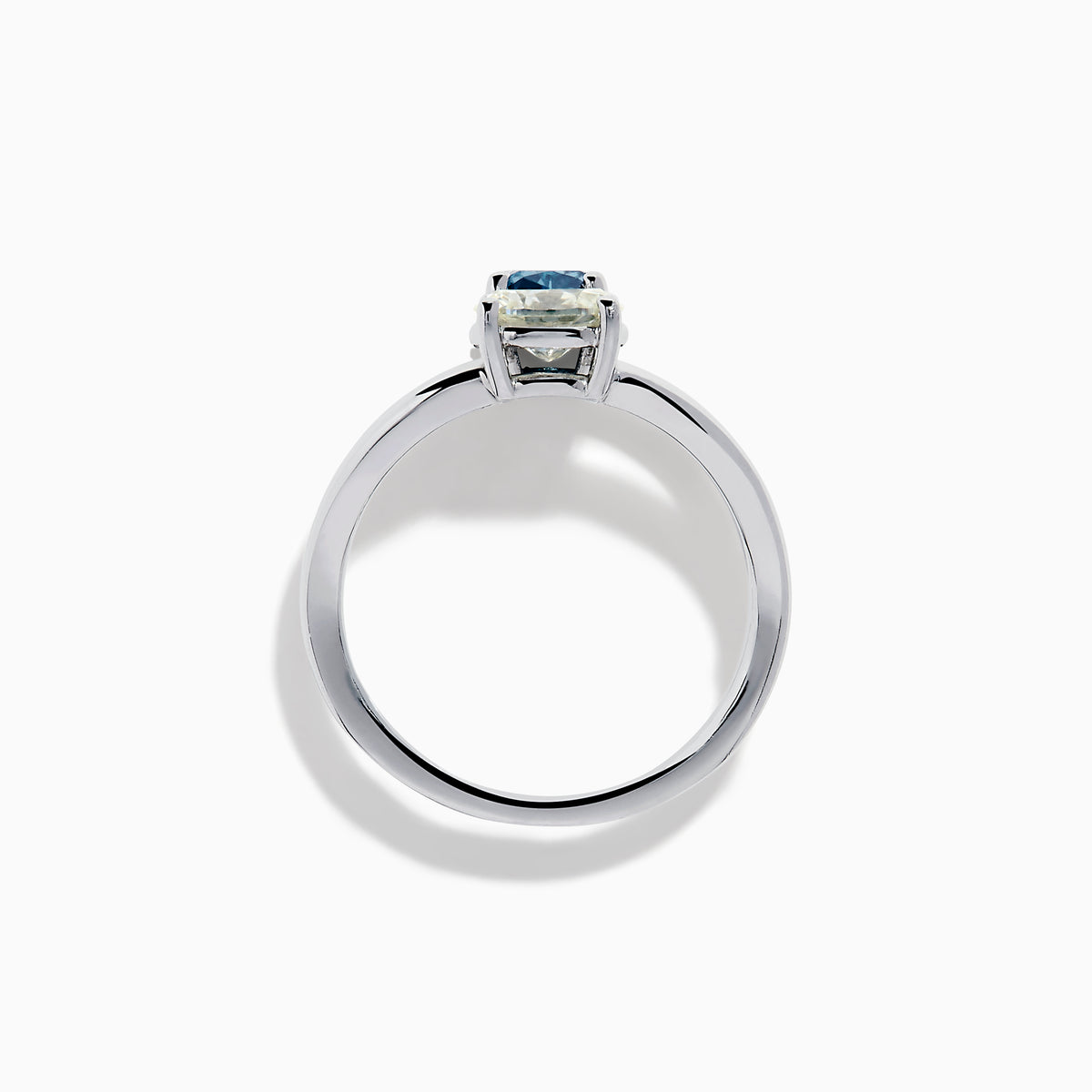 The 14K White Gold Blue and White Diamond Split Shank Ring features a clear oval and blue cushion-cut gemstone set side by side on a minimalist band, showcasing striking contrast between the blue and white diamond accents.