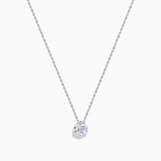 The Lab Grown Diamond Earring and Necklace Set in 14K White Gold features a heart-shaped diamond pendant on a silver necklace and matching heart-shaped diamond stud earrings, all showcased on a white background.
