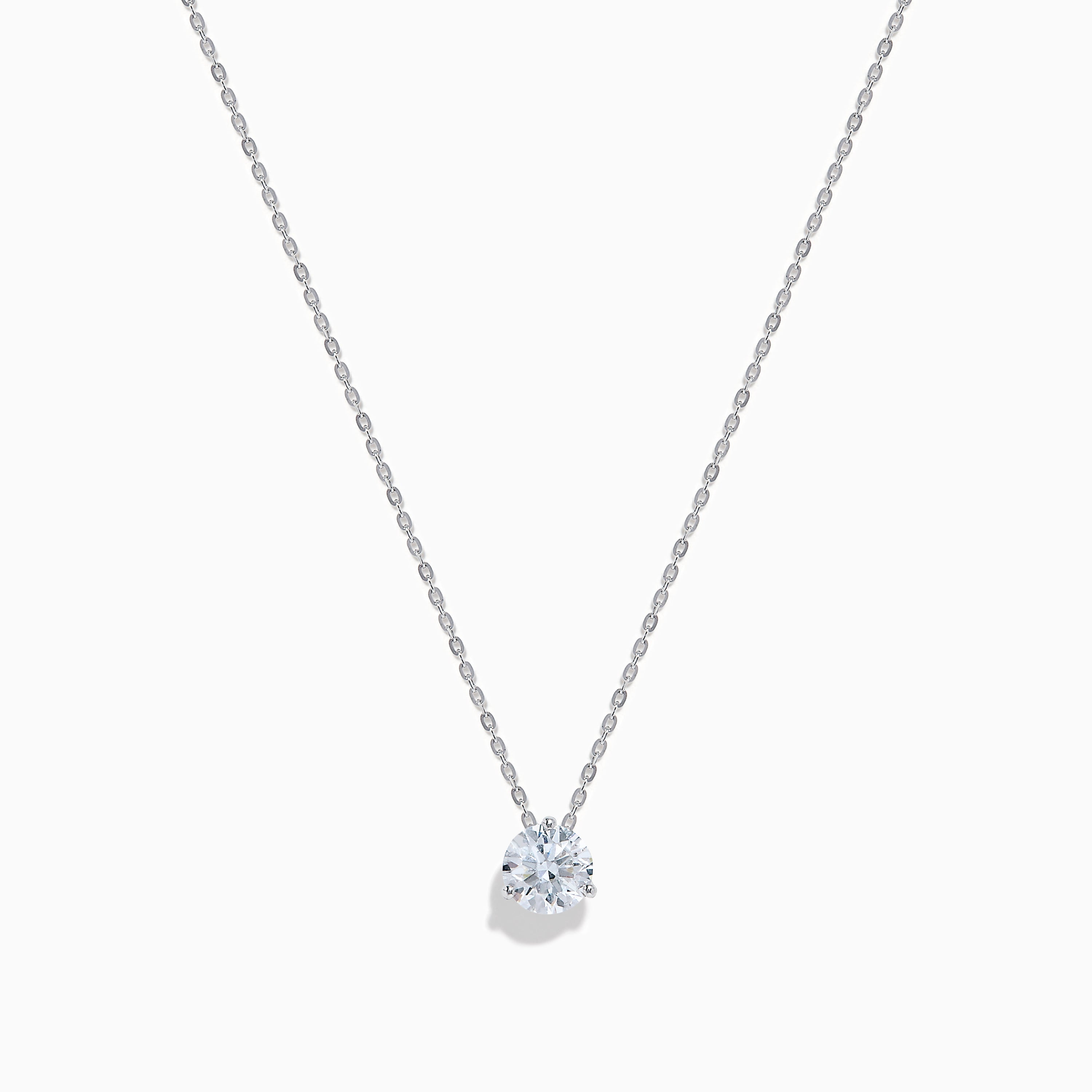 The Lab Grown Diamond Earring and Necklace Set in 14K White Gold features a heart-shaped diamond pendant on a silver necklace and matching heart-shaped diamond stud earrings, all showcased on a white background.