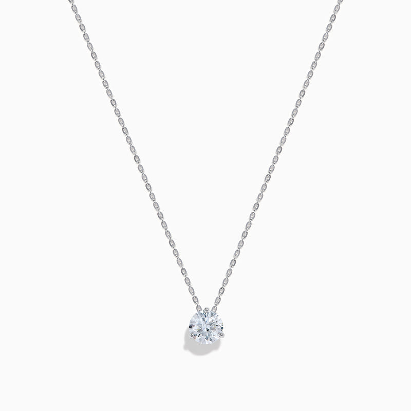 The Lab Grown Diamond Earring and Necklace Set in 14K White Gold features a heart-shaped diamond pendant on a silver necklace and matching heart-shaped diamond stud earrings, all showcased on a white background.