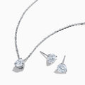 The Lab Grown Diamond Earring and Necklace Set in 14K White Gold features a heart-shaped diamond pendant on a silver necklace and matching heart-shaped diamond stud earrings, all showcased on a white background.