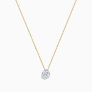 The Lab Grown Diamond Earring and Necklace Set in 14K Yellow Gold features a round diamond pendant and matching gold stud earrings, each showcasing a single round lab grown diamond, displayed on a white background.