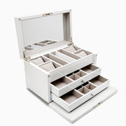 The Jewelry Box - White features sturdy wood construction, a mirrored hinged lid, cushioned sections for rings and watches, two open drawers with multiple compartments, all lined with light beige fabric. Compact dimensions for convenient storage.
