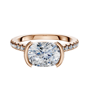 A 14K rose gold engagement ring featuring a half bezel east/west cathedral dome setting with a central stone and a 1-row pave of smaller diamonds along the 2.5mm band.