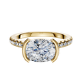 The 14K Yellow Gold Bezel Half Bezel East/West Cathedral Dome 1-Row-Pave 2.5mm Engagement Ring features an oval center set east-west with a bezel, accented by a row of pave diamonds along the band.