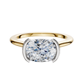 The 14K Two Tone Bezel Half Bezel East/West Cathedral Dome 1.5mm Engagement Ring features a modern cushion-cut diamond set in a stylish white metal setting, displayed against a plain white background.