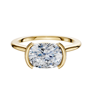 The 18K Yellow Gold Bezel Half Bezel East/West Cathedral Dome 1.5mm Engagement Ring showcases a round brilliant-cut diamond in a modern bezel setting with two curved prongs, displayed on a plain white background.