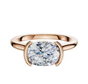 The 18K Rose Gold Bezel Half Bezel East/West Cathedral Dome 2.0mm Engagement Ring features a modern horizontal cushion-cut diamond in a sleek bezel setting, shown against a plain white background.