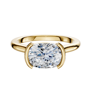 An 18K yellow gold Bezel Half Bezel East/West Cathedral Dome 2.0mm engagement ring with a cushion-cut diamond, displayed on a plain white background.