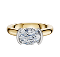 The 14K Two Tone Bezel Half Bezel East/West Cathedral Dome 3.0mm Engagement Ring features a wide band and a modern oval center stone in a partial white gold bezel setting.