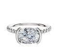 The 14K Two Tone Bezel Half Bezel East/West Classic Dome engagement ring features a 2.5mm band with a center stone set horizontally and a row of pave-set diamonds accenting the classic design.