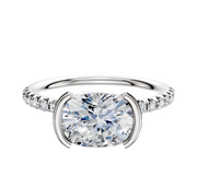 A platinum engagement ring featuring a classic dome band with a half bezel east/west setting and a row of pave diamonds, 2.5mm wide.
