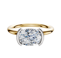 An 18K Two Tone Bezel Half Bezel East/West Classic Dome 2.0mm Engagement Ring, featuring a round diamond set in a white metal bezel, is shown from above on a plain white background.