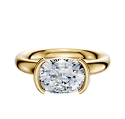A 14K yellow gold engagement ring with a classic dome 3.0mm band and a large cushion-cut diamond in an east/west half bezel setting, showcased against a plain white background.