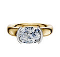 An 18K Two Tone Bezel Half Bezel East/West Classic Dome 4.0mm Engagement Ring is featured, showcasing a modern two-tone design in a sleek dome style, set against a plain white background.