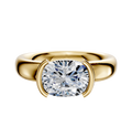 An 18K yellow gold engagement ring features a 4.0mm diamond in an East/West half bezel setting on a classic dome band, shown with the polished gold gleaming against a white background.