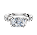A 14K two tone bezel half bezel East/West cathedral flat 1-row-pave 2.5mm engagement ring, featuring a central diamond and pave-set diamonds along the band, showcased on a plain white background.