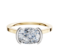 An 18K two-tone bezel half bezel East/West cathedral flat 1.5mm engagement ring, shown on a plain white background.