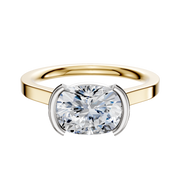 An 18K two-tone bezel half bezel East/West cathedral flat 2.0mm engagement ring with a large cushion-cut diamond set in four white metal prongs, displayed on a plain white background.