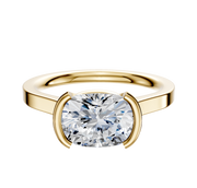An 18K yellow gold half bezel East/West cathedral flat 2.0mm engagement ring is shown with a cushion-cut diamond in a modern minimalist setting, displayed on a plain white background.