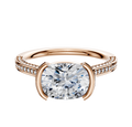 An 18K rose gold engagement ring featuring a bezel and half bezel east/west cathedral setting with a flat band, adorned with three rows of pavé diamonds and measuring 2.0mm wide.