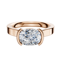 The 18K Rose Gold Bezel Half Bezel East/West Cathedral Flat 3.0mm Engagement Ring features a wide band and modern partial bezel setting, showcased against a plain white background.