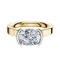 An 18K two-tone bezel half-bezel east/west cathedral flat 3.0mm engagement ring with a wide band and a cushion-cut diamond set at the center.