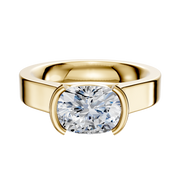 A 14K yellow gold engagement ring with a flat 4.0mm wide band, showcasing a clear diamond in an East/West cathedral half bezel setting.
