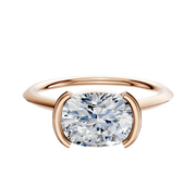 A 14K rose gold cathedral knife edge engagement ring with a 1.5mm band and an east/west bezel half setting, displayed on a plain white background.