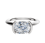 A Platinum Bezel Half Bezel East/West Cathedral Knife Edge 2.0mm Engagement Ring is shown with a large round-cut diamond in a sleek, modern setting, displayed against a white background.