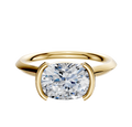A 14K yellow gold cathedral knife edge engagement ring with a 2.0mm band and a bezel half bezel east/west setting, displayed against a plain white background.