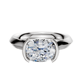 The 14K White Gold Bezel Half Bezel East/West Cathedral Knife Edge 3.0mm Engagement Ring showcases a large cushion-cut clear diamond set horizontally in a modern bezel setting, displayed on a plain white background.