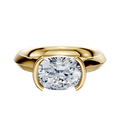 A 14K yellow gold bezel half bezel east/west cathedral knife edge 3.0mm engagement ring showcased against a white background.