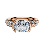 The 14K Rose Gold Bezel Half Bezel East/West Classic Knife Edge 1-Row-Pave 2.5mm Engagement Ring features a sleek design with sparkling pave diamonds along the band, displayed on a white background.