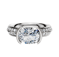 The 14K Two Tone Bezel Half Bezel East/West Classic Knife Edge 1-Row-Pave 2.5mm Engagement Ring features a unique east/west-set center, classic knife-edge design, and a band accented with a single row of sparkling pave diamonds.