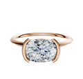 A 14K rose gold engagement ring featuring a bezel half bezel east/west classic knife edge 1.5mm band, displayed against a plain white background.