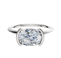 An 18K white gold engagement ring with a classic knife edge and 1.5mm band, featuring a half bezel east/west setting, displayed against a plain white background.