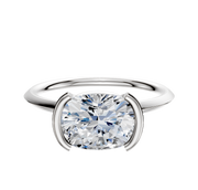 An 18K white gold engagement ring with a classic knife edge and 1.5mm band, featuring a half bezel east/west setting, displayed against a plain white background.