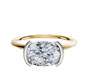 A 14K two-tone bezel half-bezel east/west classic knife edge 1.5mm engagement ring featuring a prominent round diamond in a modern setting.