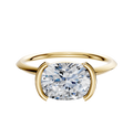 A 14K yellow gold bezel half bezel east/west classic knife edge 1.5mm engagement ring is shown against a plain white background.