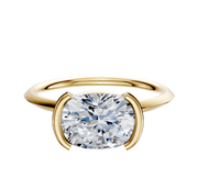 An 18K yellow gold bezel half bezel east/west classic knife edge 1.5mm engagement ring is shown on a plain white background.