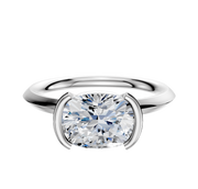 A Platinum Bezel Half Bezel East/West Classic Knife Edge 2.0mm Engagement Ring featuring a large, round diamond set in a modern, minimalist setting against a white background.