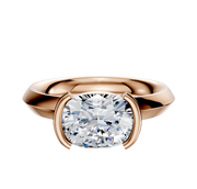 An 18K rose gold bezel half bezel east/west classic knife edge 3.0mm engagement ring is shown, featuring a modern setting on a plain white background.
