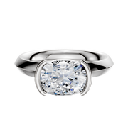 An 18K white gold engagement ring with a 3.0mm knife edge band in a classic east/west half bezel setting, displayed against a plain white background.