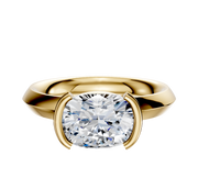 An 18K yellow gold Bezel Half Bezel East/West Classic Knife Edge 3.0mm engagement ring is showcased with a modern, minimalist setting, displayed on a plain white background.