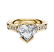 A 14K yellow gold East/West cathedral engagement ring with a bezel-set centerpiece and a flat band featuring a single row of pave-set diamonds, shown on a white background.